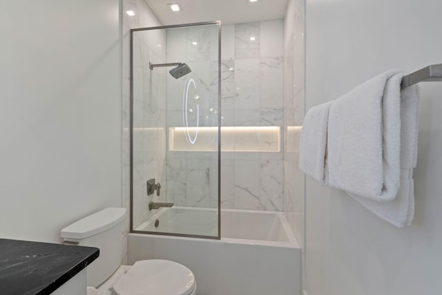 full bathroom featuring shower / bath combination with glass door, vanity, and toilet