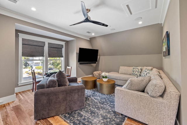 living room with ceiling fan and light hardwood / wood-style flooring