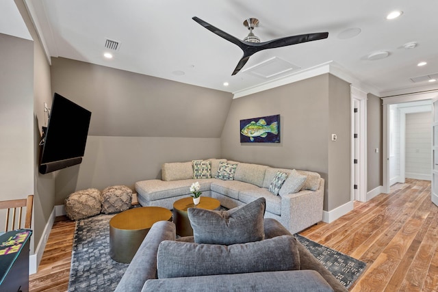 living room featuring light wood-type flooring, vaulted ceiling, ceiling fan, and ornamental molding