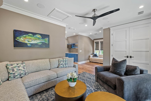 living room with ceiling fan, hardwood / wood-style floors, and ornamental molding