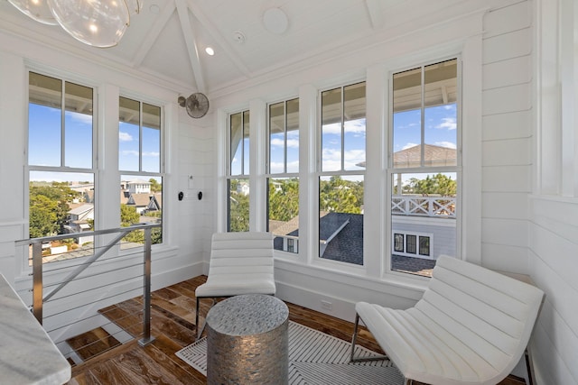 sunroom / solarium with a healthy amount of sunlight and lofted ceiling