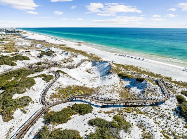 drone / aerial view featuring a water view and a view of the beach