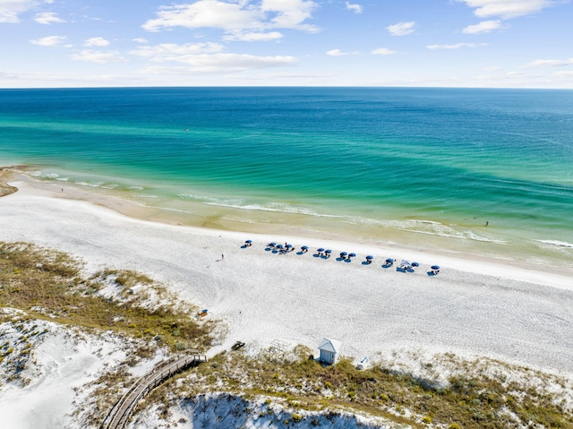 drone / aerial view with a water view and a beach view