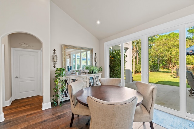 dining area featuring dark hardwood / wood-style floors and high vaulted ceiling