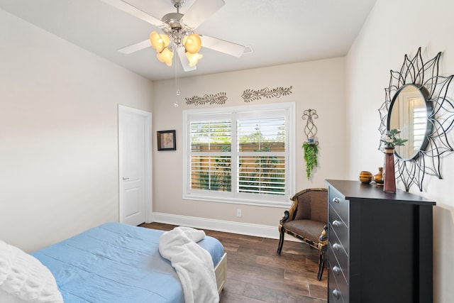 bedroom with ceiling fan and dark hardwood / wood-style flooring