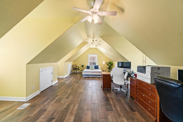 home office featuring ceiling fan, dark hardwood / wood-style flooring, and vaulted ceiling