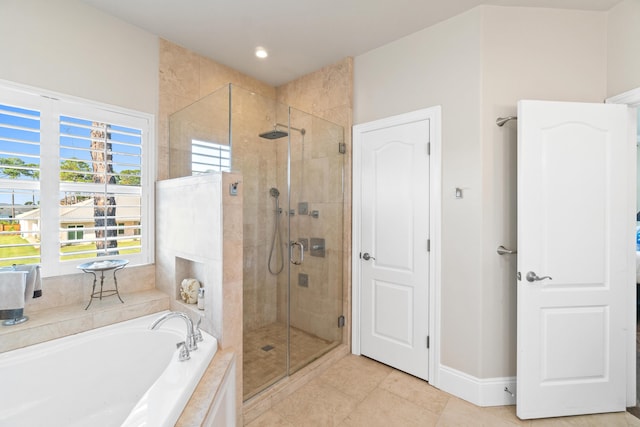 bathroom with tile patterned floors and independent shower and bath