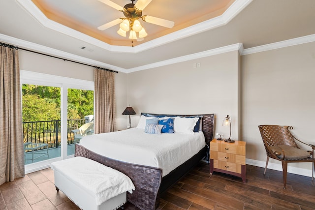 bedroom with ceiling fan, dark hardwood / wood-style flooring, crown molding, and a tray ceiling