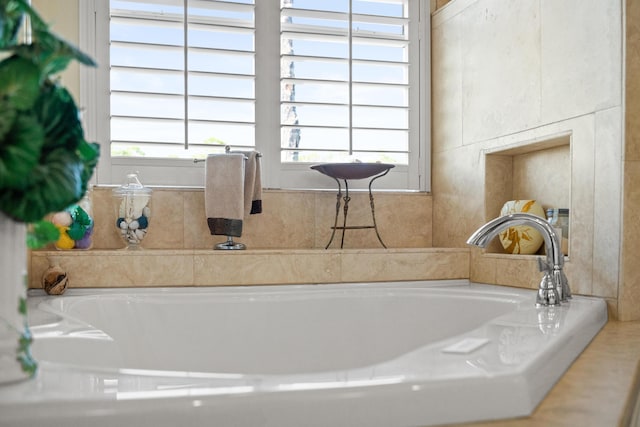 bathroom with plenty of natural light and a bath