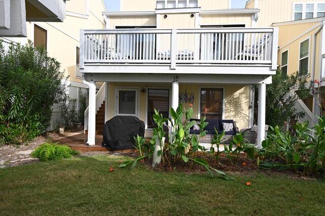 back of house with a yard and a balcony