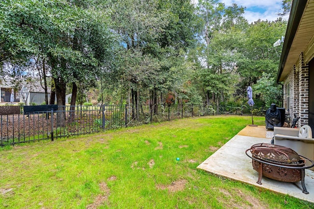 view of yard with an outdoor fire pit and a patio