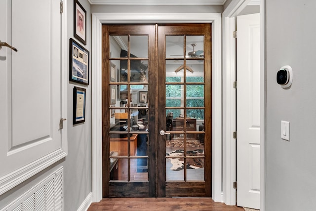 doorway to outside featuring french doors, hardwood / wood-style floors, and ornamental molding