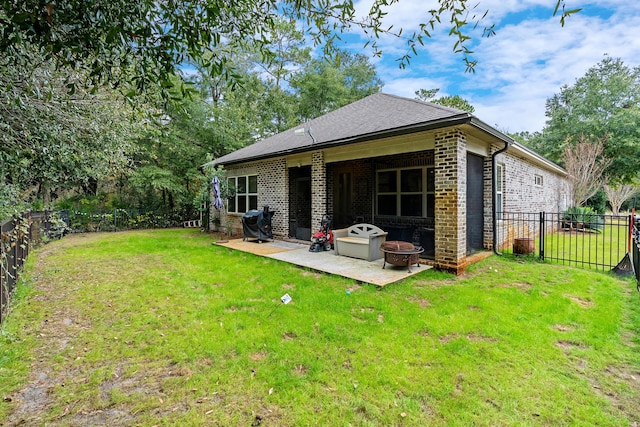 back of house featuring a yard and a patio area