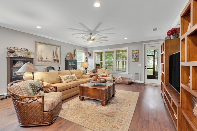 living room with dark hardwood / wood-style floors, ceiling fan, and ornamental molding