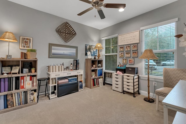 office area featuring light carpet and ceiling fan