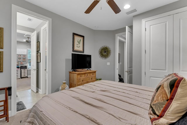 tiled bedroom featuring a closet and ceiling fan