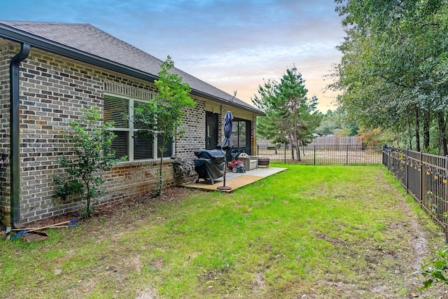 yard at dusk with a patio