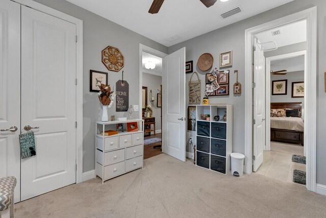 bedroom featuring ceiling fan and light carpet