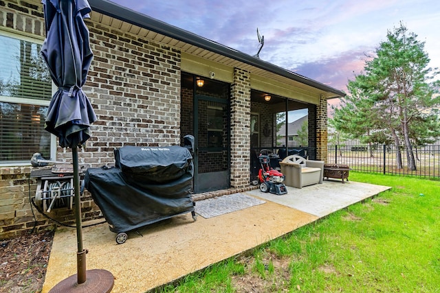 patio terrace at dusk featuring grilling area