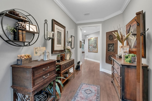 hallway with wood-type flooring and ornamental molding