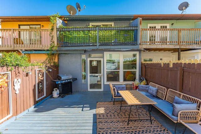 back of property with outdoor lounge area and a wooden deck