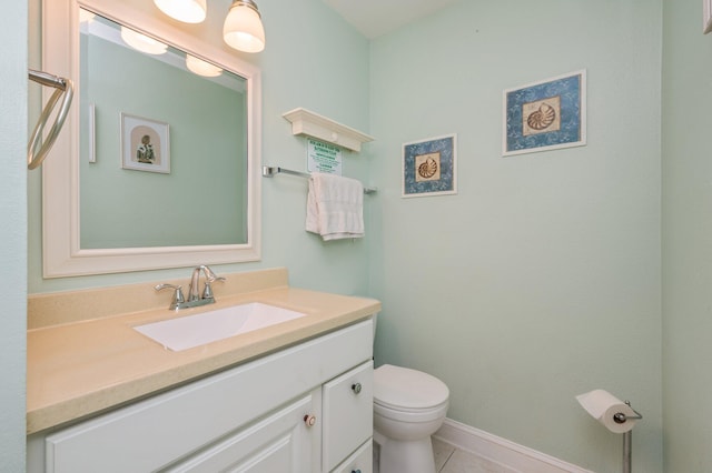 bathroom featuring tile patterned floors, vanity, and toilet