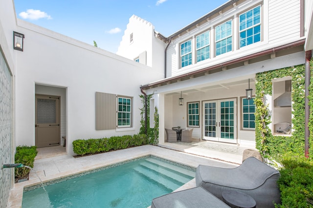 back of property with french doors and a patio