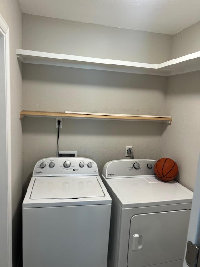 washroom with washing machine and clothes dryer