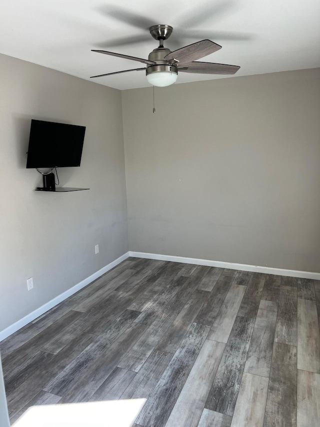 unfurnished room with dark hardwood / wood-style floors and ceiling fan