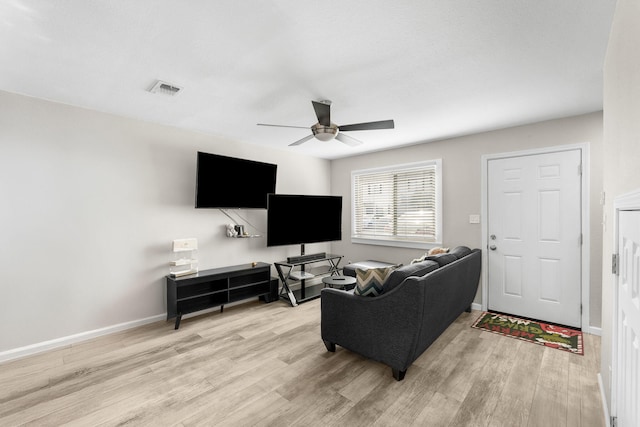 living room with light wood-type flooring and ceiling fan