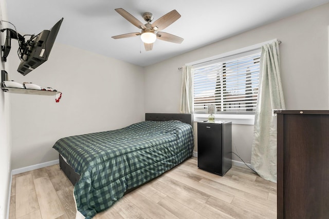 bedroom featuring ceiling fan and light hardwood / wood-style flooring