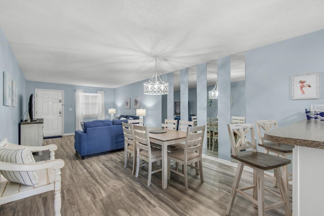 dining area featuring hardwood / wood-style floors and a textured ceiling