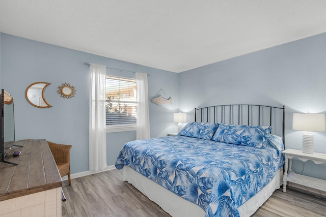 bedroom with wood-type flooring