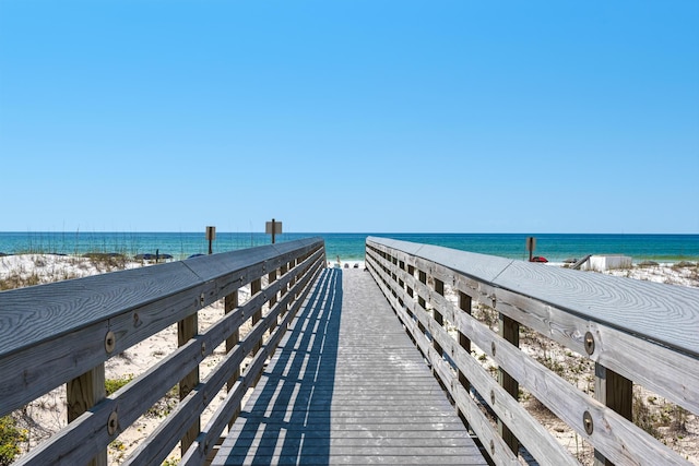 exterior space featuring a water view and a beach view