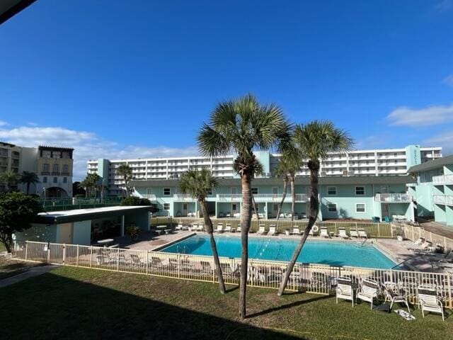 view of pool with a patio area and a lawn