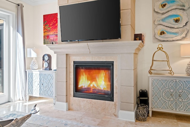 room details with a tile fireplace and crown molding