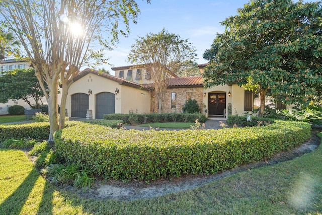 mediterranean / spanish home with a garage