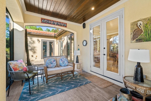 sunroom featuring wooden ceiling and french doors