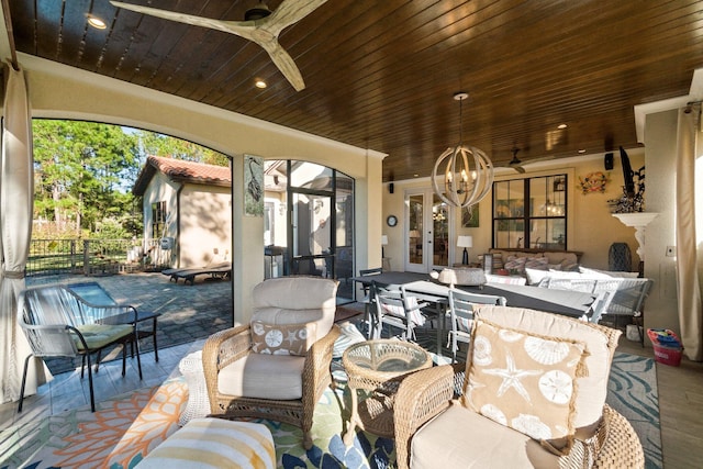 view of patio featuring french doors, an outdoor living space, and ceiling fan