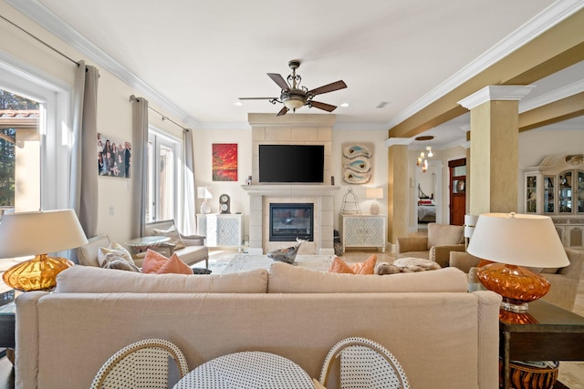 living room with crown molding, a fireplace, and ceiling fan