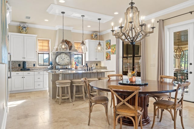 dining area featuring crown molding and a chandelier