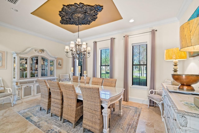 dining space featuring a tray ceiling, crown molding, and an inviting chandelier