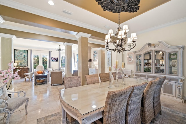 dining area with ornate columns, crown molding, and an inviting chandelier