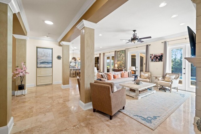 living room with french doors, decorative columns, ceiling fan, and crown molding