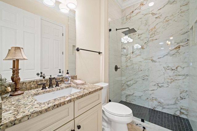 bathroom featuring a tile shower, vanity, and toilet