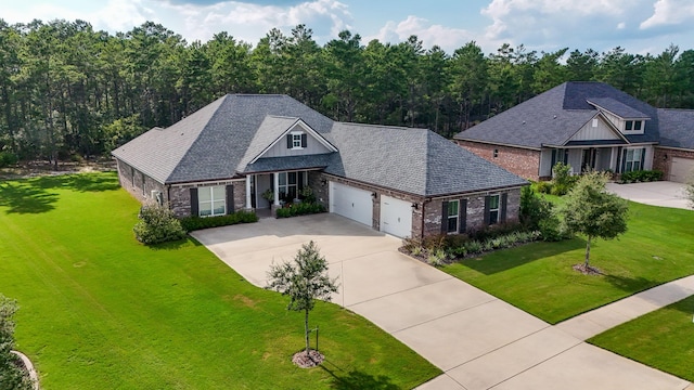 craftsman house with a front yard and a garage