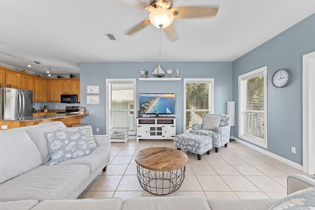 living room with ceiling fan and light tile patterned floors