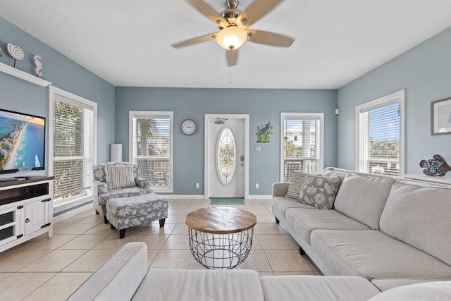 tiled living room with a wealth of natural light and ceiling fan