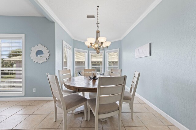 dining space featuring crown molding, light tile patterned flooring, and a notable chandelier