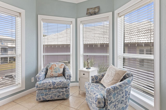 living area featuring a healthy amount of sunlight and light tile patterned flooring